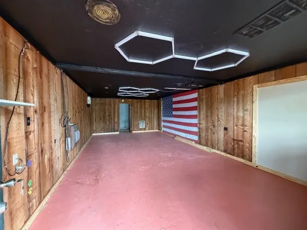 a view of an empty room with wooden walls
