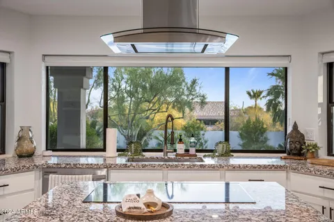 a large kitchen with lots of counter space and windows