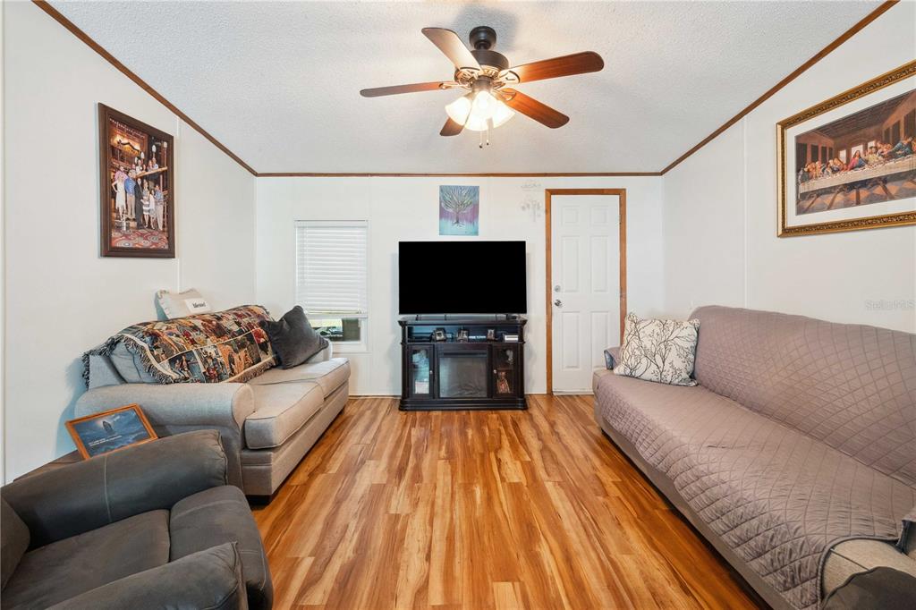 4131 Burwell Road Webster, FL 33597 - Photo 11 of 61 a living room with furniture and a flat screen tv