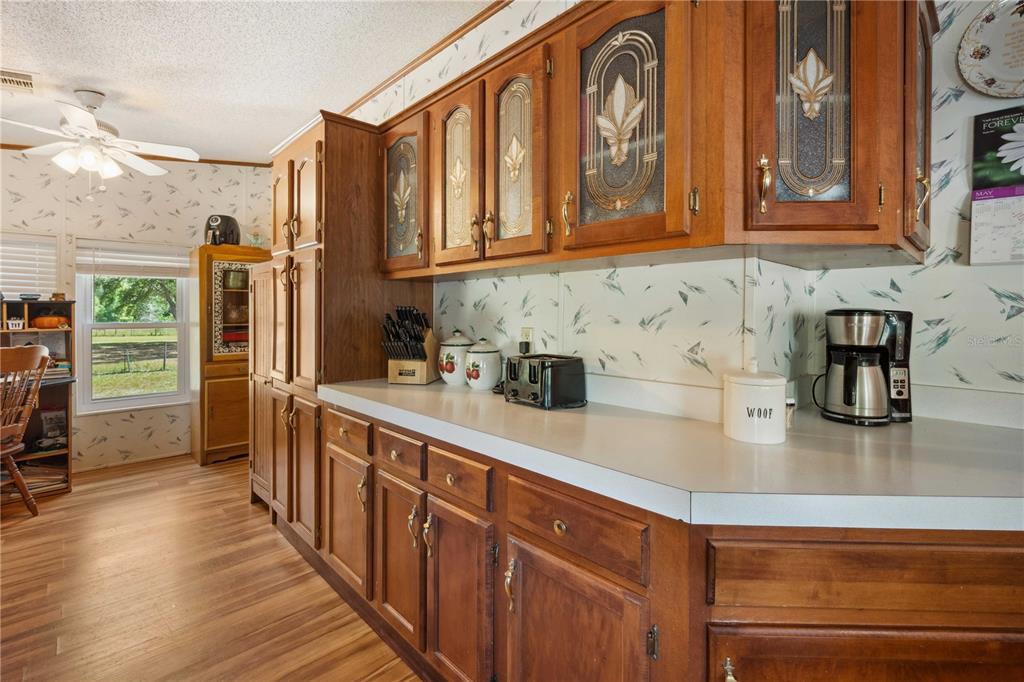 4131 Burwell Road Webster, FL 33597 - Photo 15 of 61 a kitchen with stainless steel appliances granite countertop a refrigerator a stove and a sink with cabinets