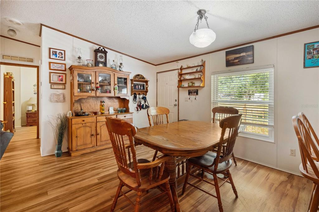 4131 Burwell Road Webster, FL 33597 - Photo 18 of 61 a view of a dining room with furniture window and wooden floor