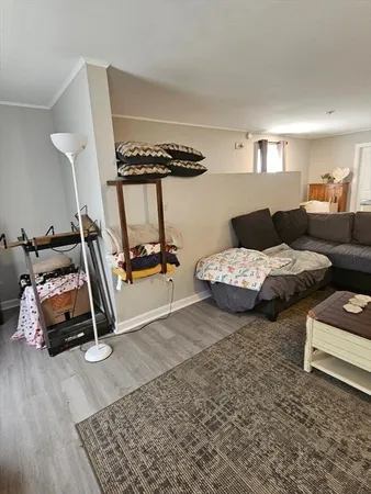a bedroom with furniture and a wooden floor