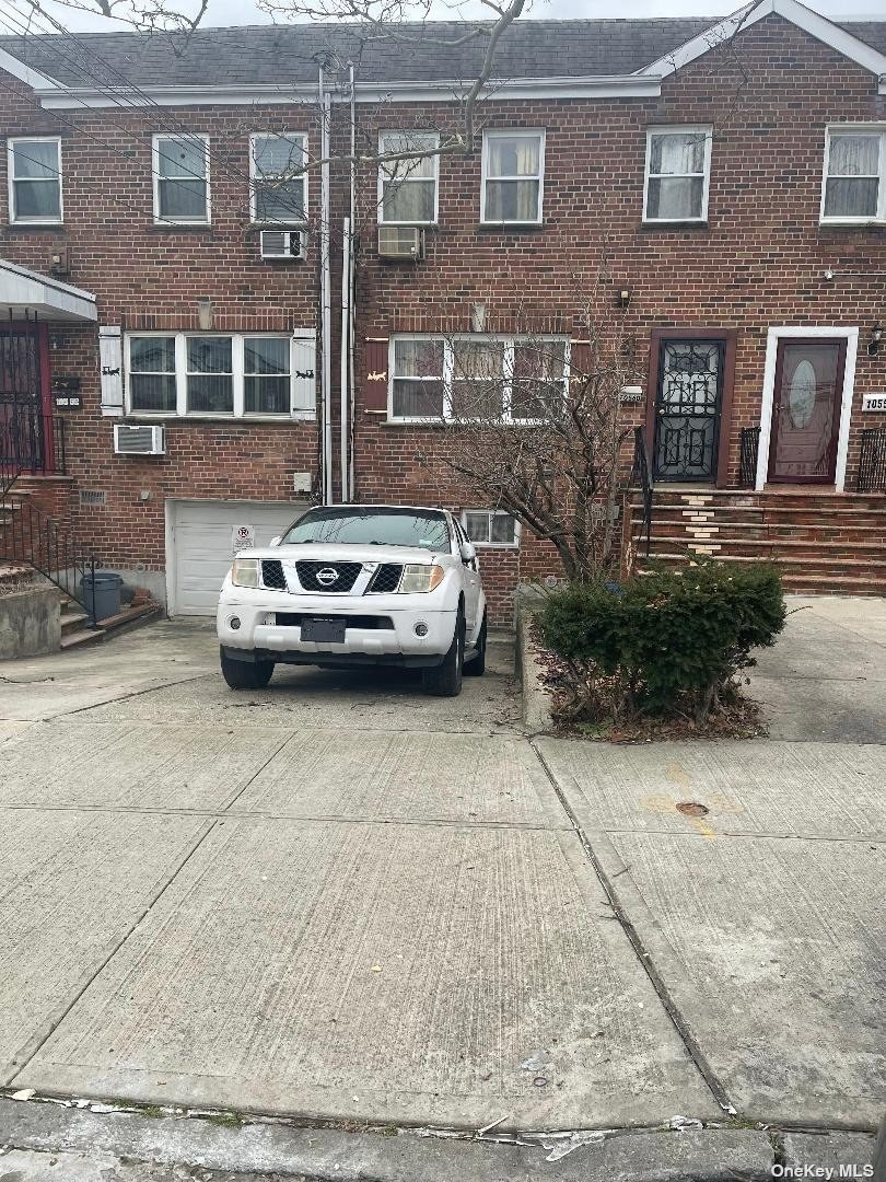 a car parked in front of a brick building