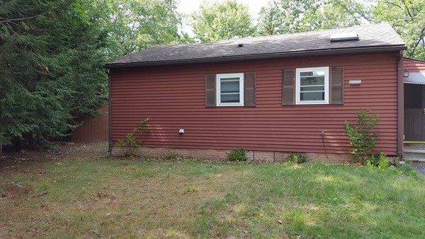 39 Ridge Way Sturbridge, MA 01566 - Photo 3 of 23 a brick house with a small yard and large trees