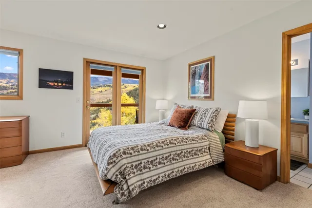 a bedroom with a bed couch and a window