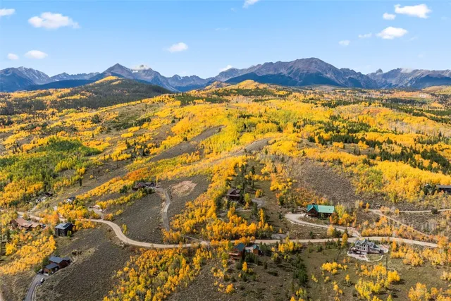 a living room with furniture a flat screen tv and a large window