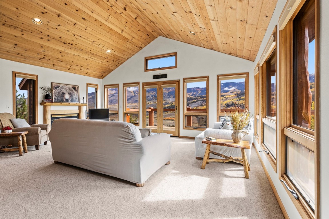 1007 Blue Ridge Road Silverthorne, CO 80498 - Photo 26 of 50 a living room with furniture and a dining table next to a large window