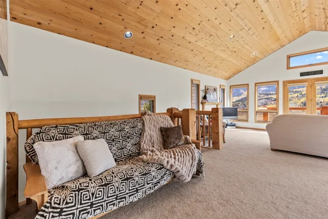 a kitchen with granite countertop a refrigerator oven a sink dishwasher and white cabinets with wooden floor