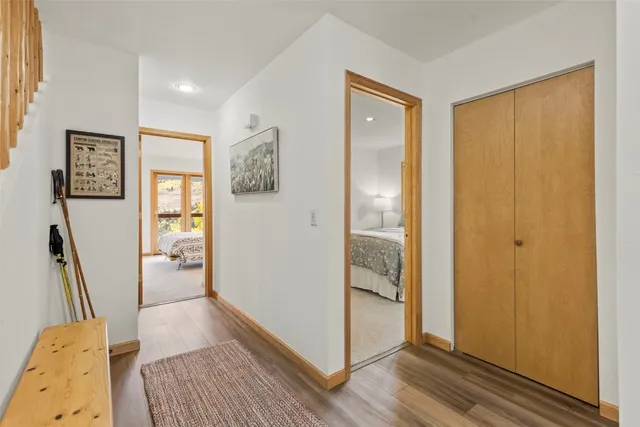 a view of a hallway and a livingroom with wooden floor