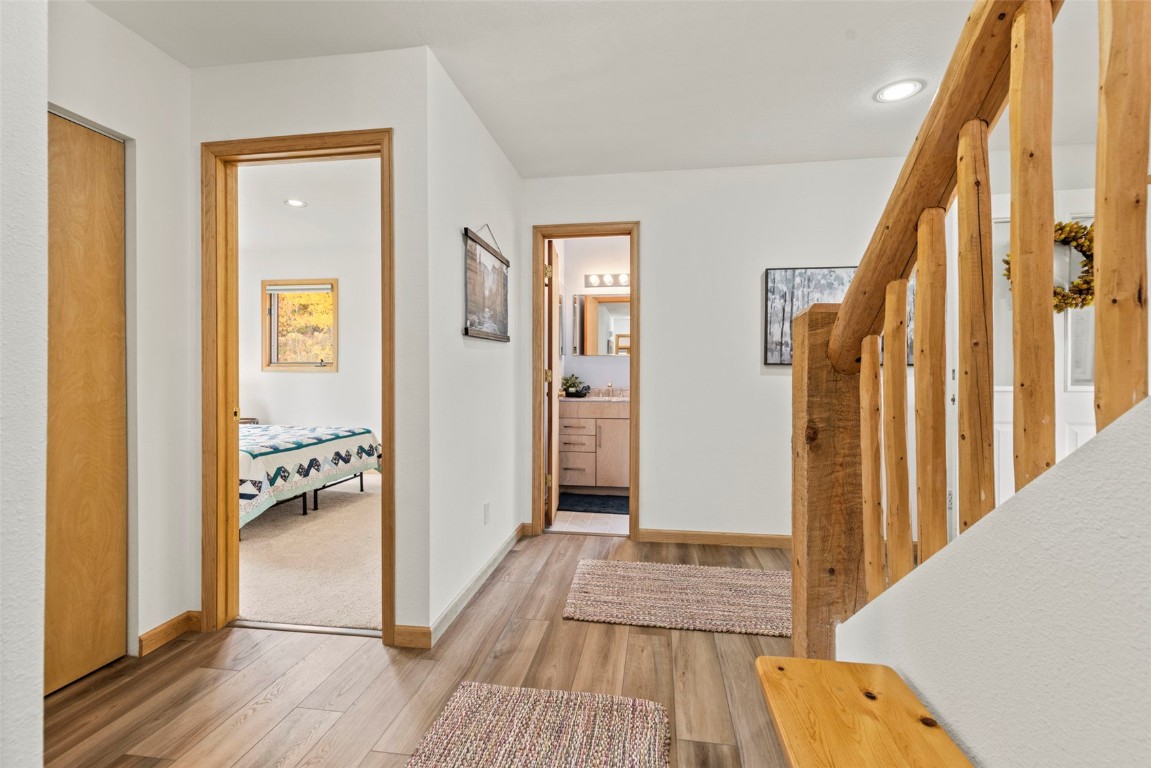 1007 Blue Ridge Road Silverthorne, CO 80498 - Photo 10 of 50 a view of a hallway with wooden floor and staircase