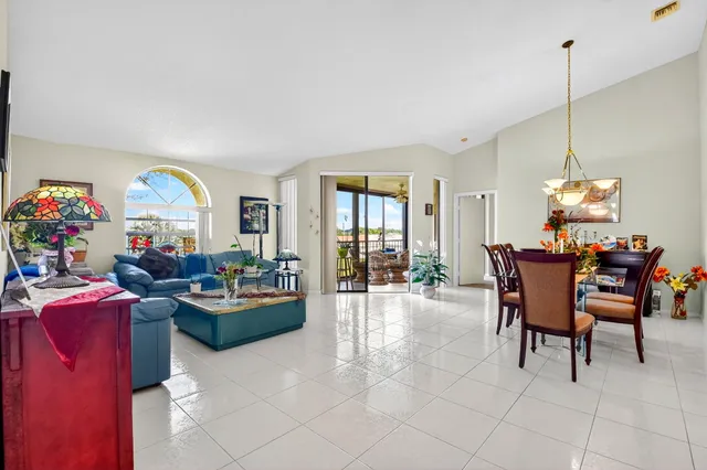 a dining room with furniture and a window