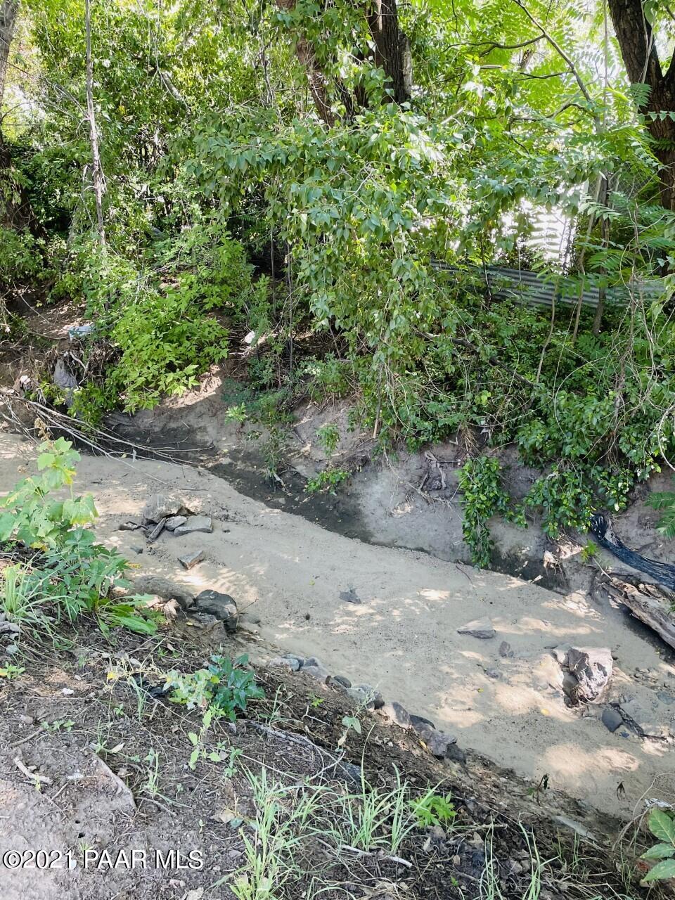 741 Gail Gardner Way, Unit I Prescott, AZ 86305 - Photo 15 of 16 a view of a dirt road with trees in the background