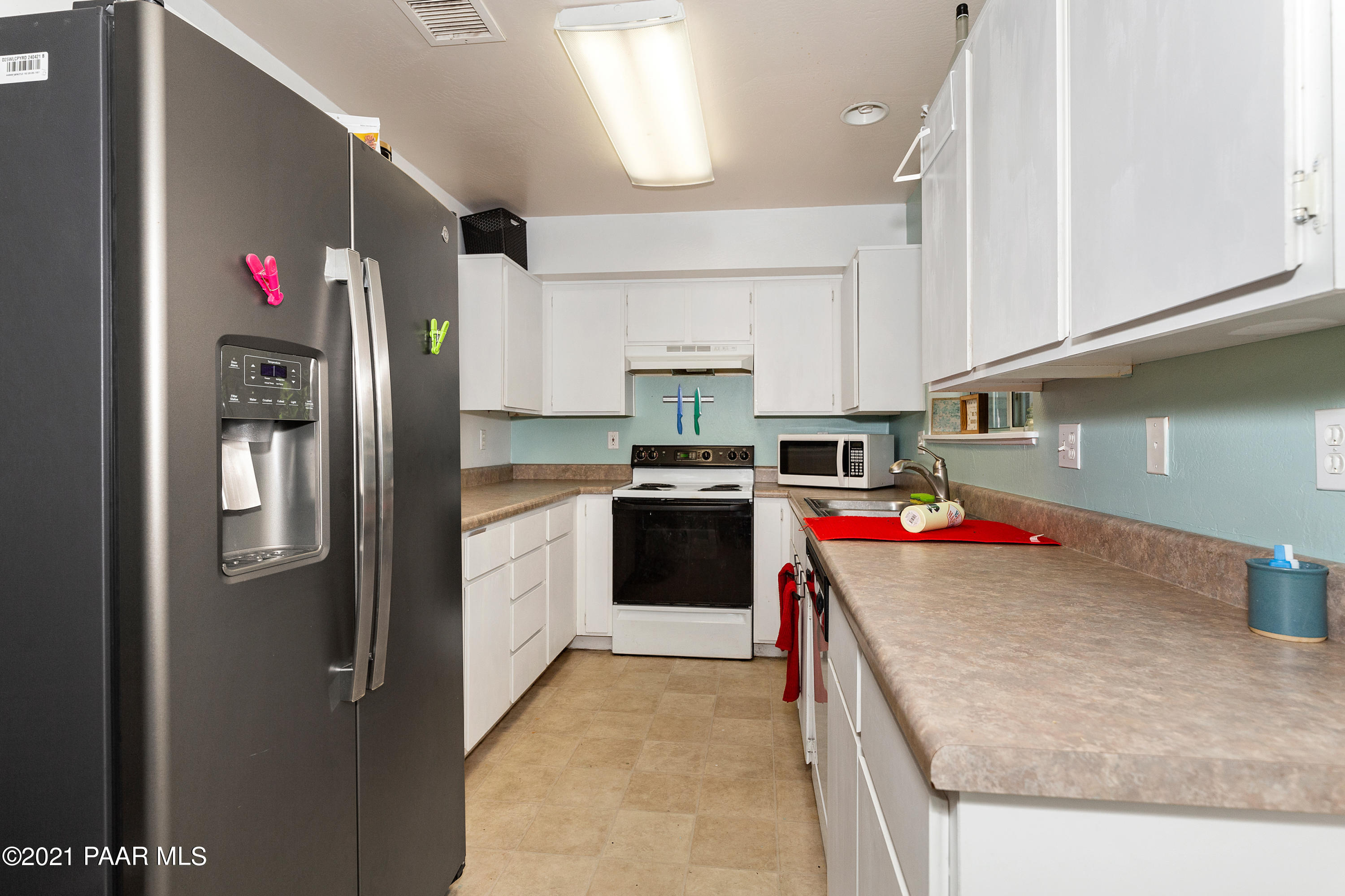 741 Gail Gardner Way, Unit I Prescott, AZ 86305 - Photo 5 of 16 a kitchen with stainless steel appliances granite countertop a refrigerator a stove and a sink