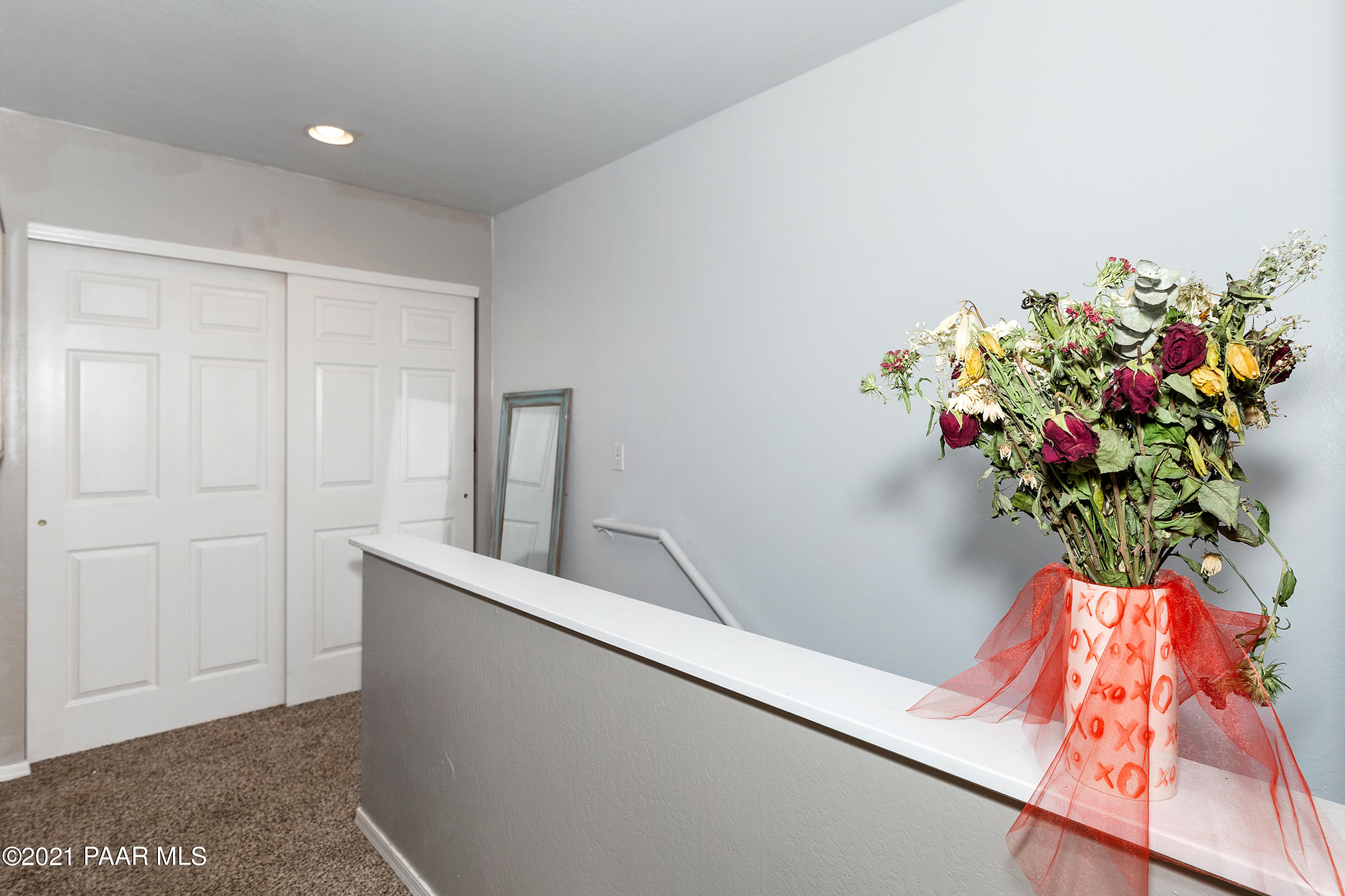 741 Gail Gardner Way, Unit I Prescott, AZ 86305 - Photo 9 of 16 a vase of flowers sitting on a floor