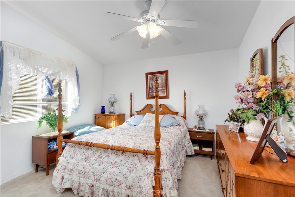 29520 Piani Road Pearblossom, CA 93553 - Photo 16 of 34 a bed room with furniture and a chandelier