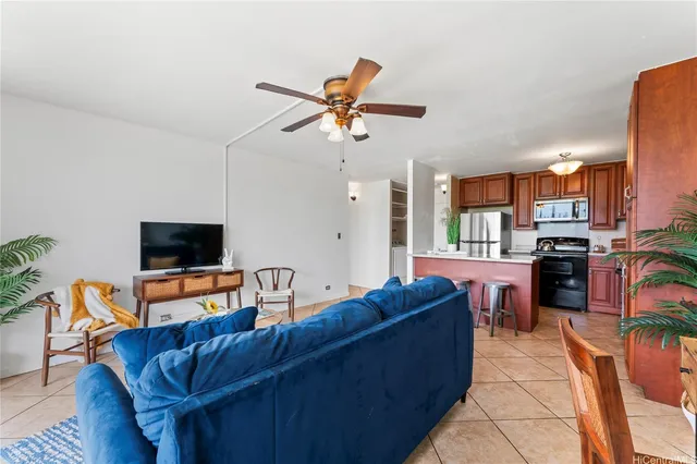a living room with furniture kitchen view and a flat screen tv