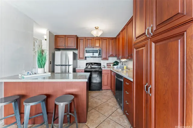 a kitchen with stainless steel appliances granite countertop a refrigerator and a stove top oven