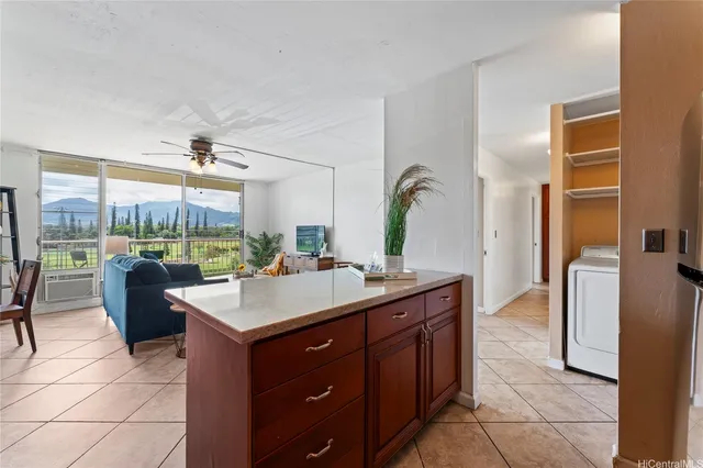 a room with a sink a counter top space and living room