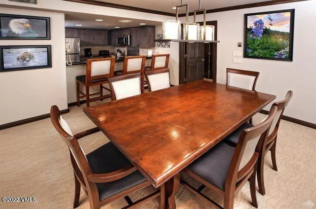 a view of a dining room with furniture and a chandelier