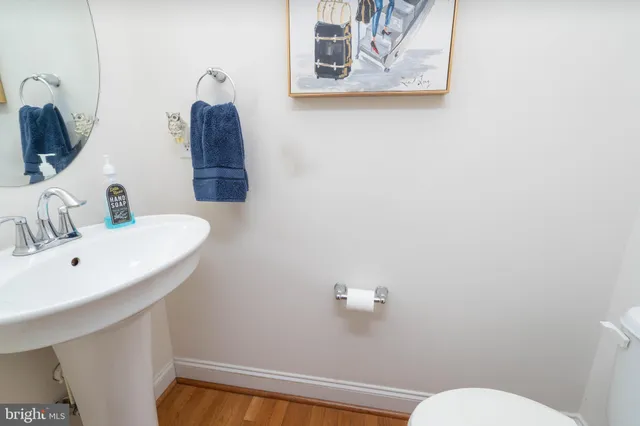a bathroom with a sink mirror and toilet