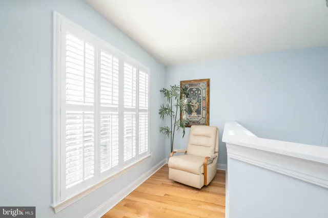 a bedroom with furniture and a large window