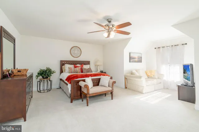 a bed room with a bed and a chandelier