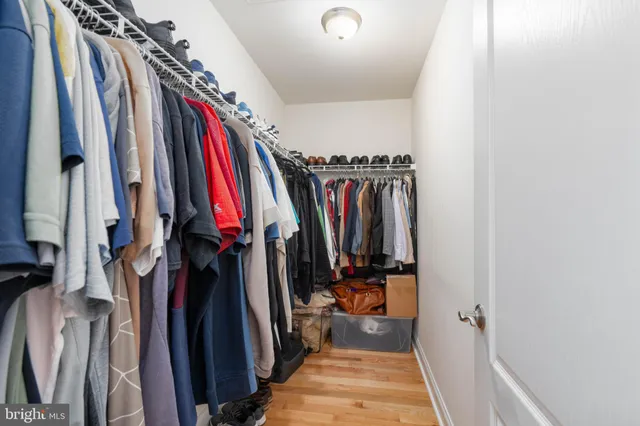 a view of walk in closet with clothes
