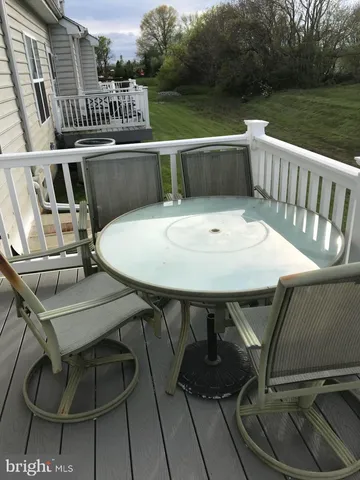 a balcony with table and chairs