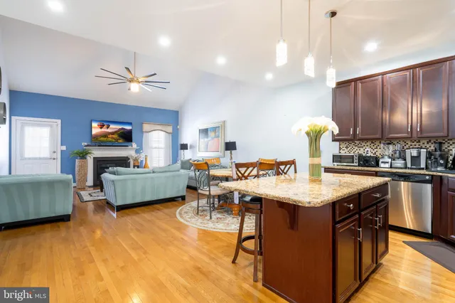 a kitchen island with granite countertop a sink cabinets and window