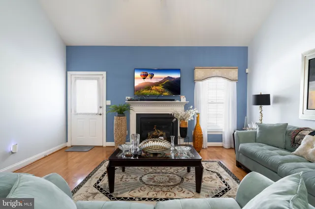 a living room with furniture a fireplace and a flat screen tv