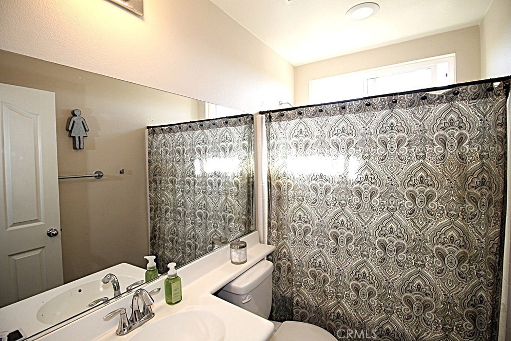 924 Condor Street Barstow, CA 92311 - Photo 25 of 52 a bathroom with a sink toilet and shower