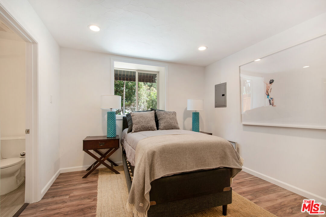 9696 Antelope Road Beverly Hills, CA 90210 - Photo 15 of 29 a bedroom with a bed and a table