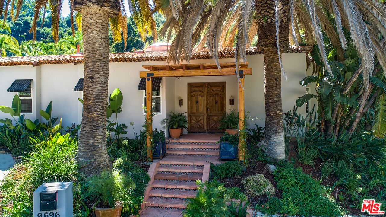 9696 Antelope Road Beverly Hills, CA 90210 - Photo 4 of 29 a front view of a house with plants and garden