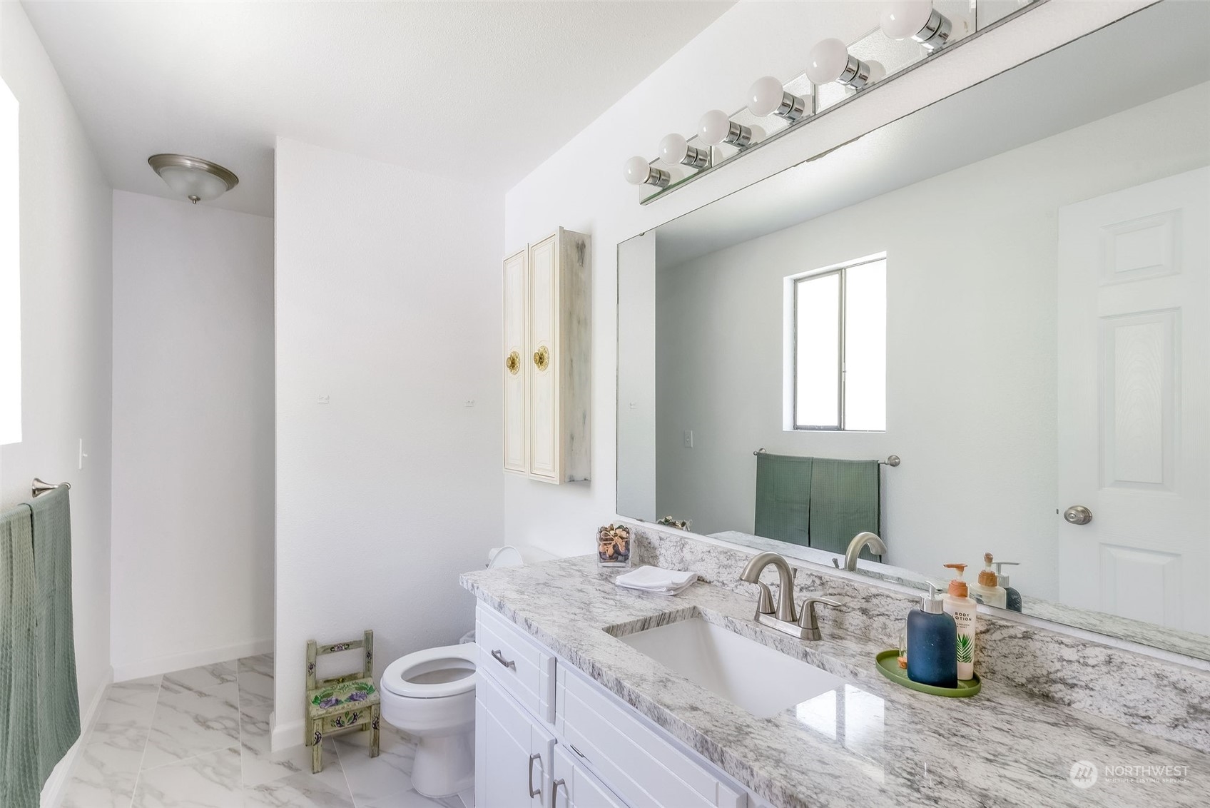 26435 Kingsview Loop Northeast Kingston, WA 98346 - Photo 12 of 25 a bathroom with a granite countertop sink mirror and toilet