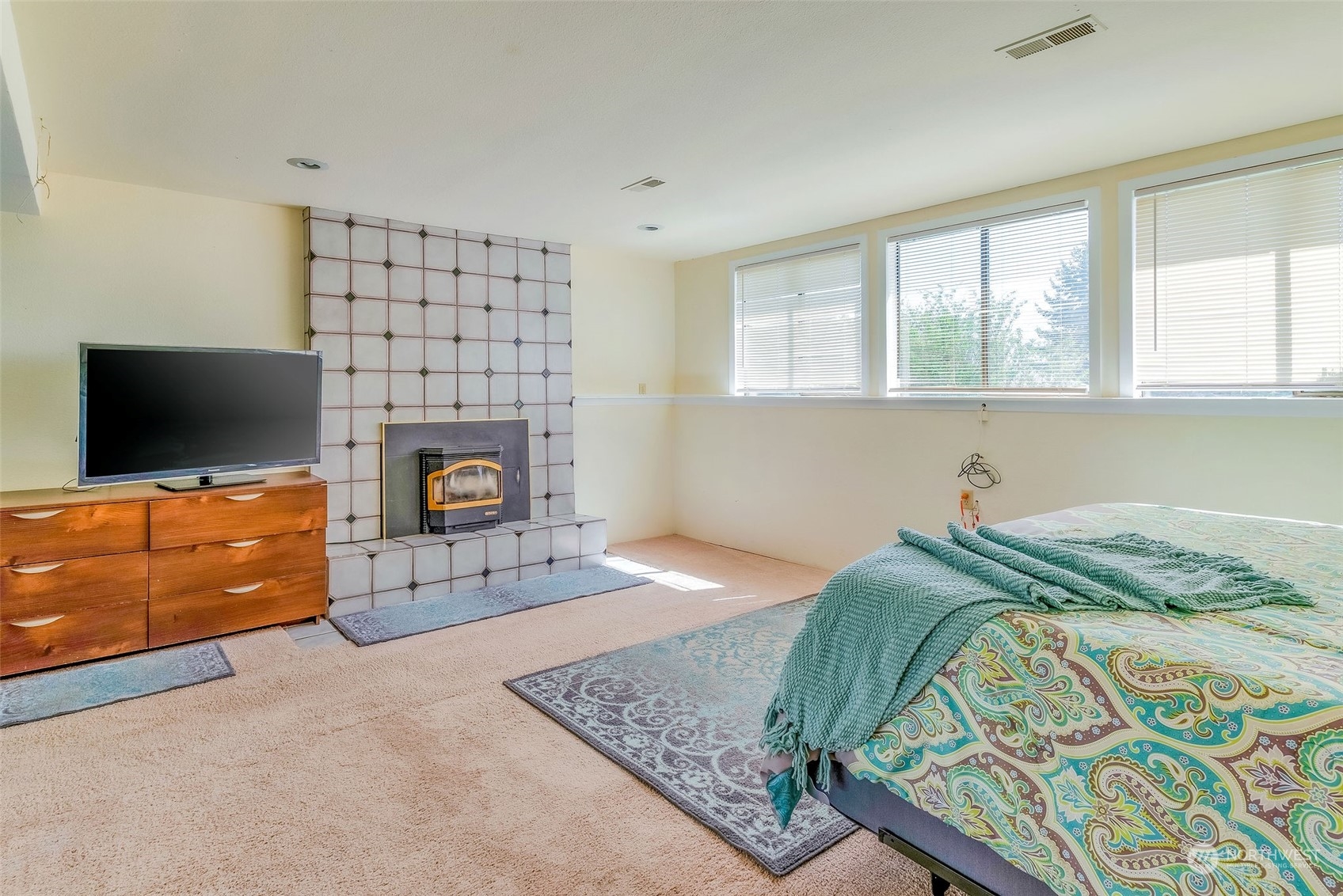 26435 Kingsview Loop Northeast Kingston, WA 98346 - Photo 17 of 25 a bedroom with a bed and flat screen tv