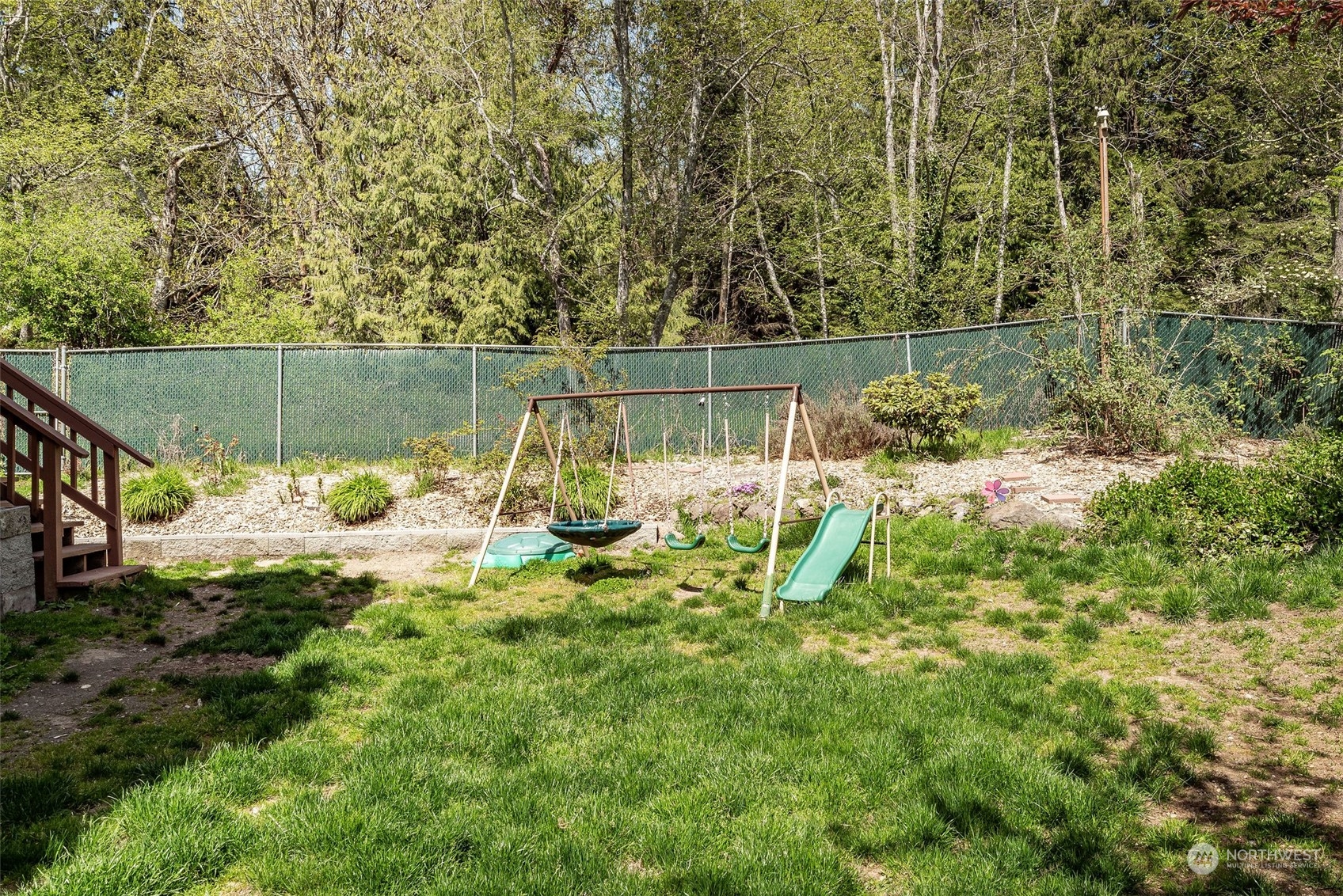 26435 Kingsview Loop Northeast Kingston, WA 98346 - Photo 22 of 25 a backyard of a house with lots of green space and fountain