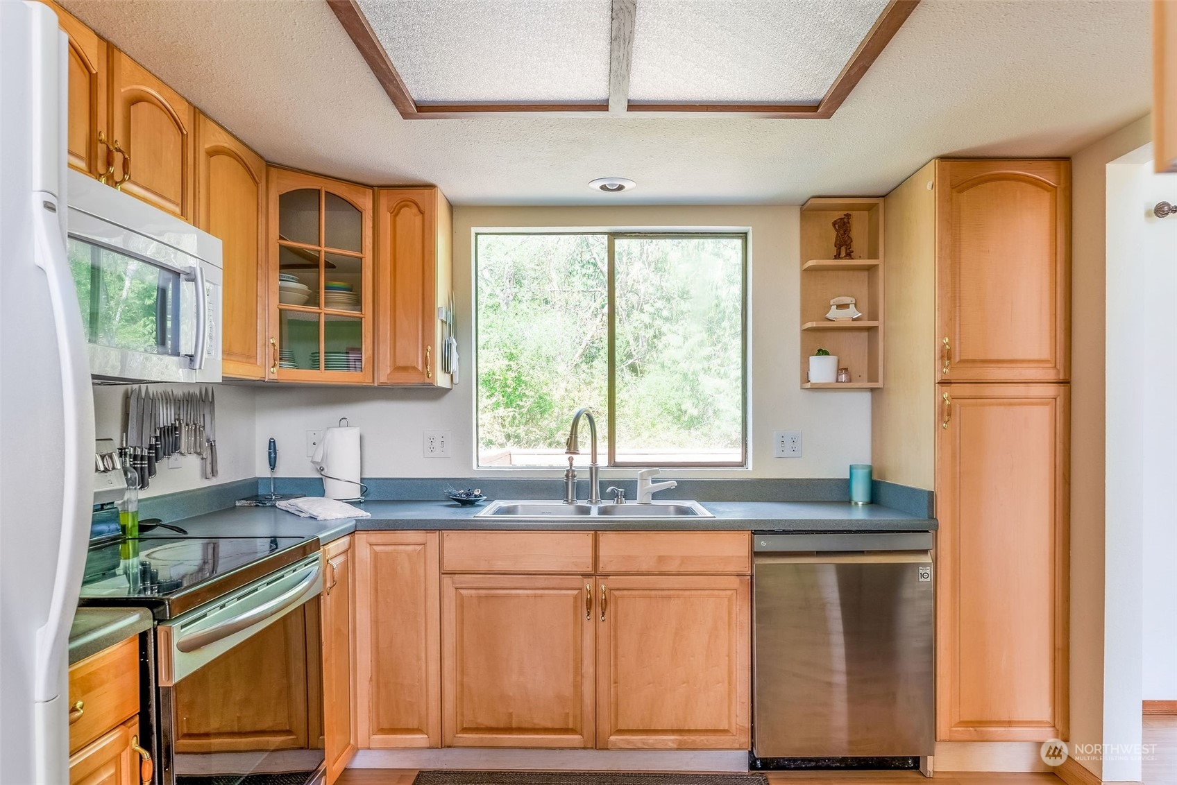 26435 Kingsview Loop Northeast Kingston, WA 98346 - Photo 9 of 25 a kitchen with stainless steel appliances granite countertop a refrigerator and a sink