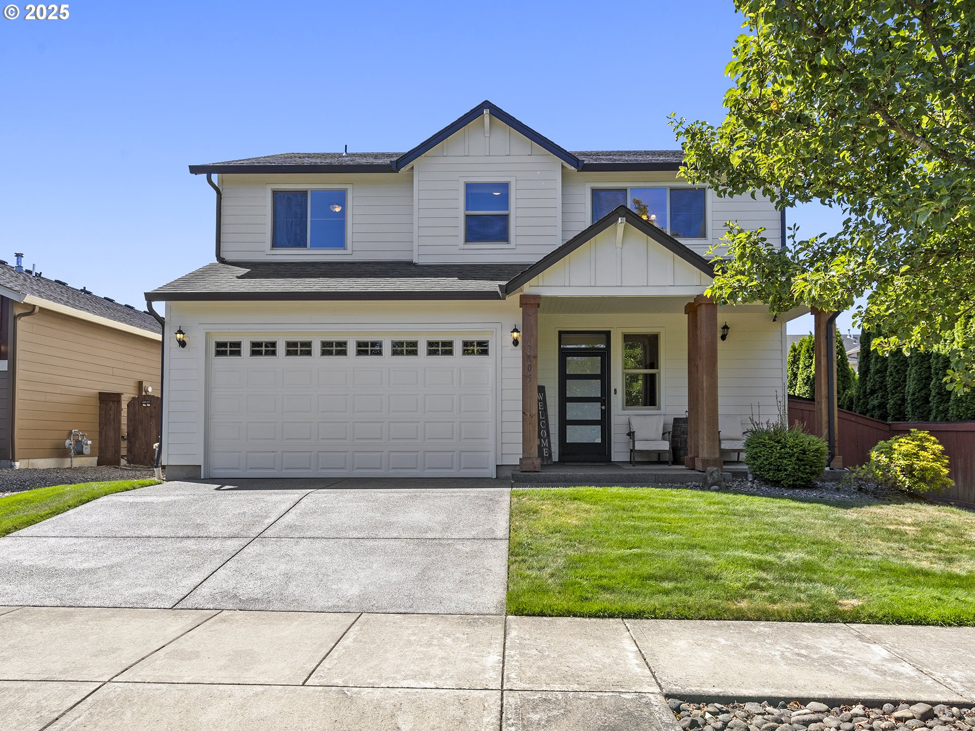 3805 North 3rd Circle Ridgefield, WA 98642 - Photo 1 of 30 a front view of a house with a yard and garage