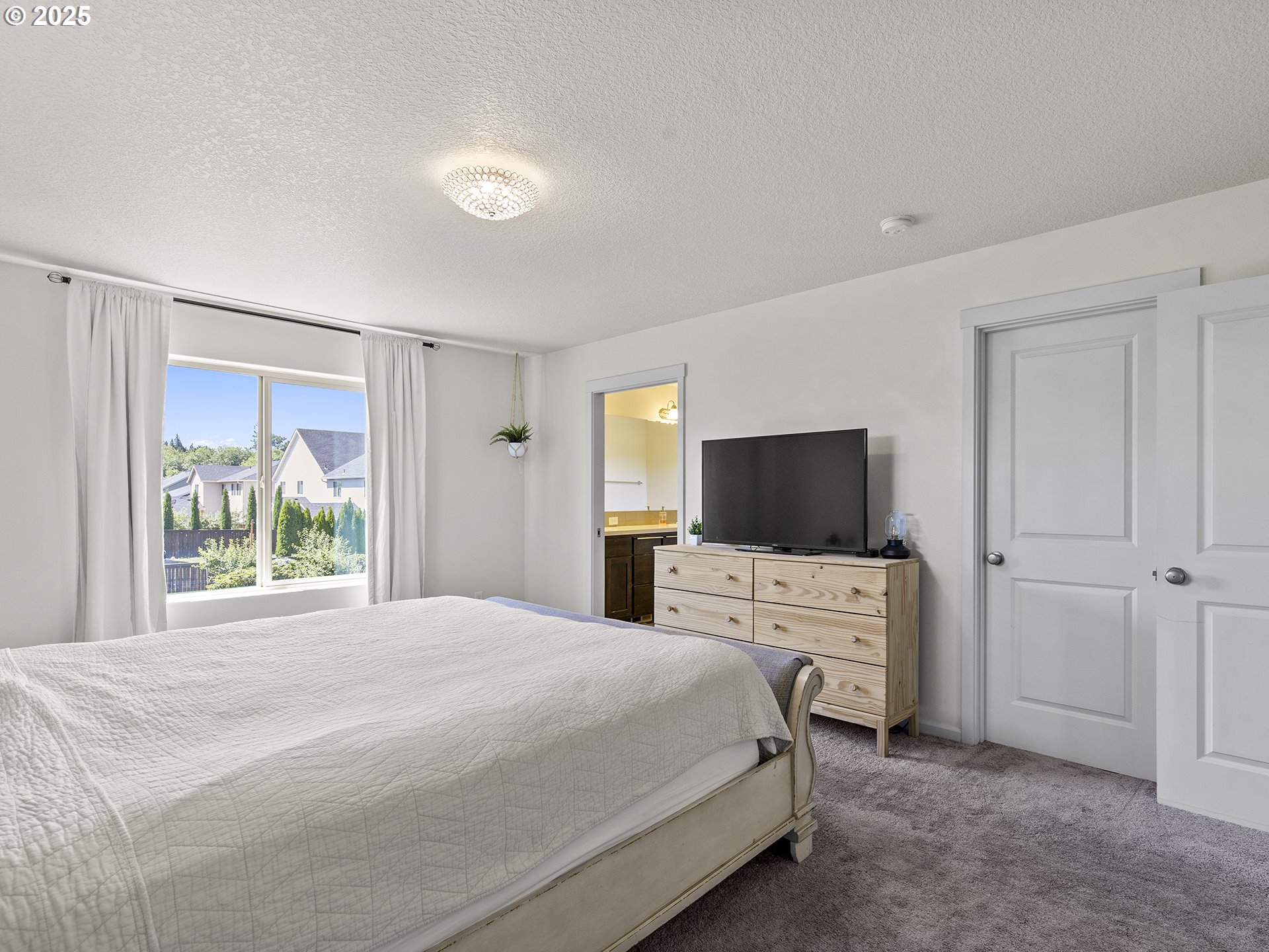 3805 North 3rd Circle Ridgefield, WA 98642 - Photo 13 of 30 a bedroom with a bed and a flat screen tv