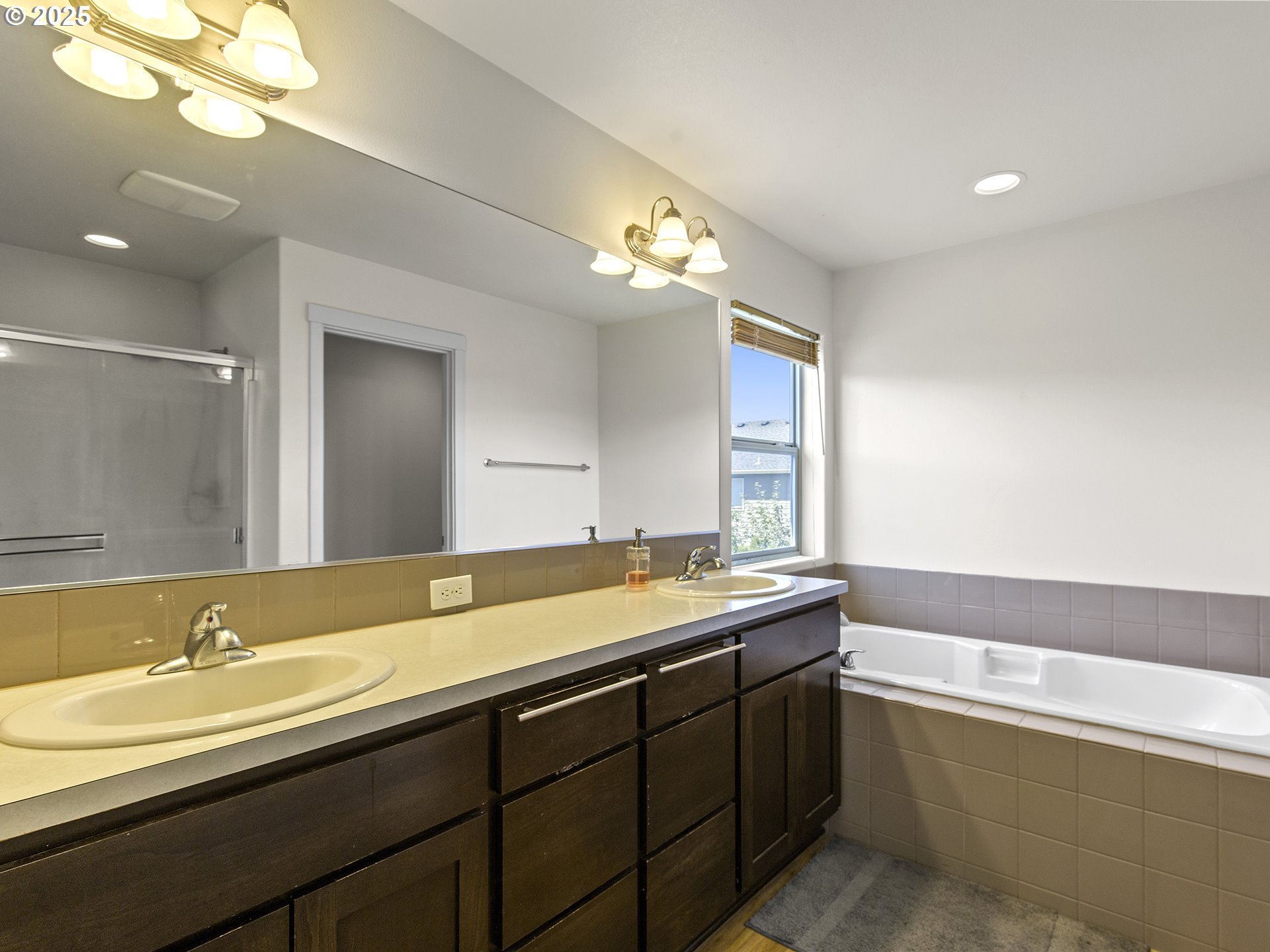 3805 North 3rd Circle Ridgefield, WA 98642 - Photo 14 of 30 a bathroom with a tub sink and mirror
