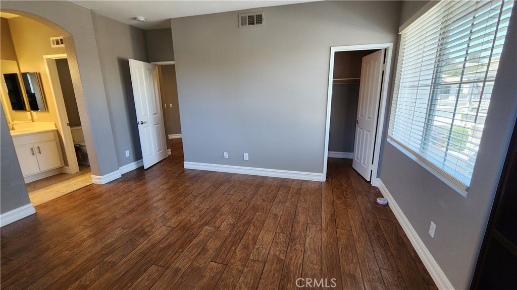 3 Camino Celeste San Clemente, CA 92673 - Photo 12 of 16 an empty room with wooden floor and windows