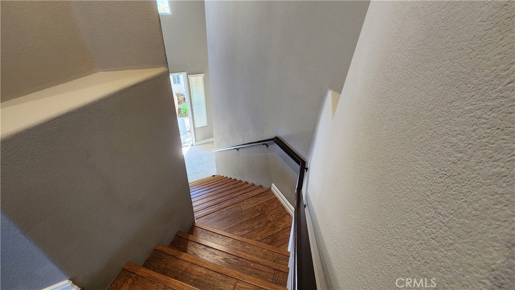 3 Camino Celeste San Clemente, CA 92673 - Photo 4 of 16 a view of staircase with wooden floor and white walls