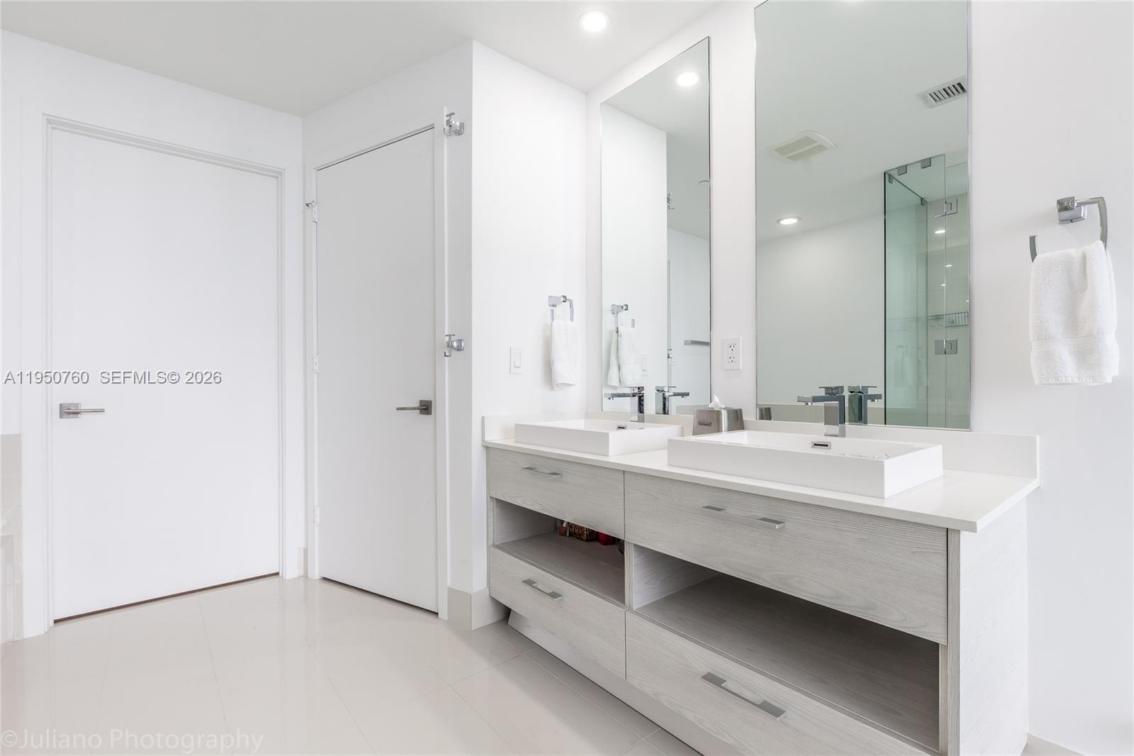 55 Southwest 9th Street, Unit PH4603 Miami, FL 33130 - Photo 22 of 48 a bathroom with double vanity sink and a mirror