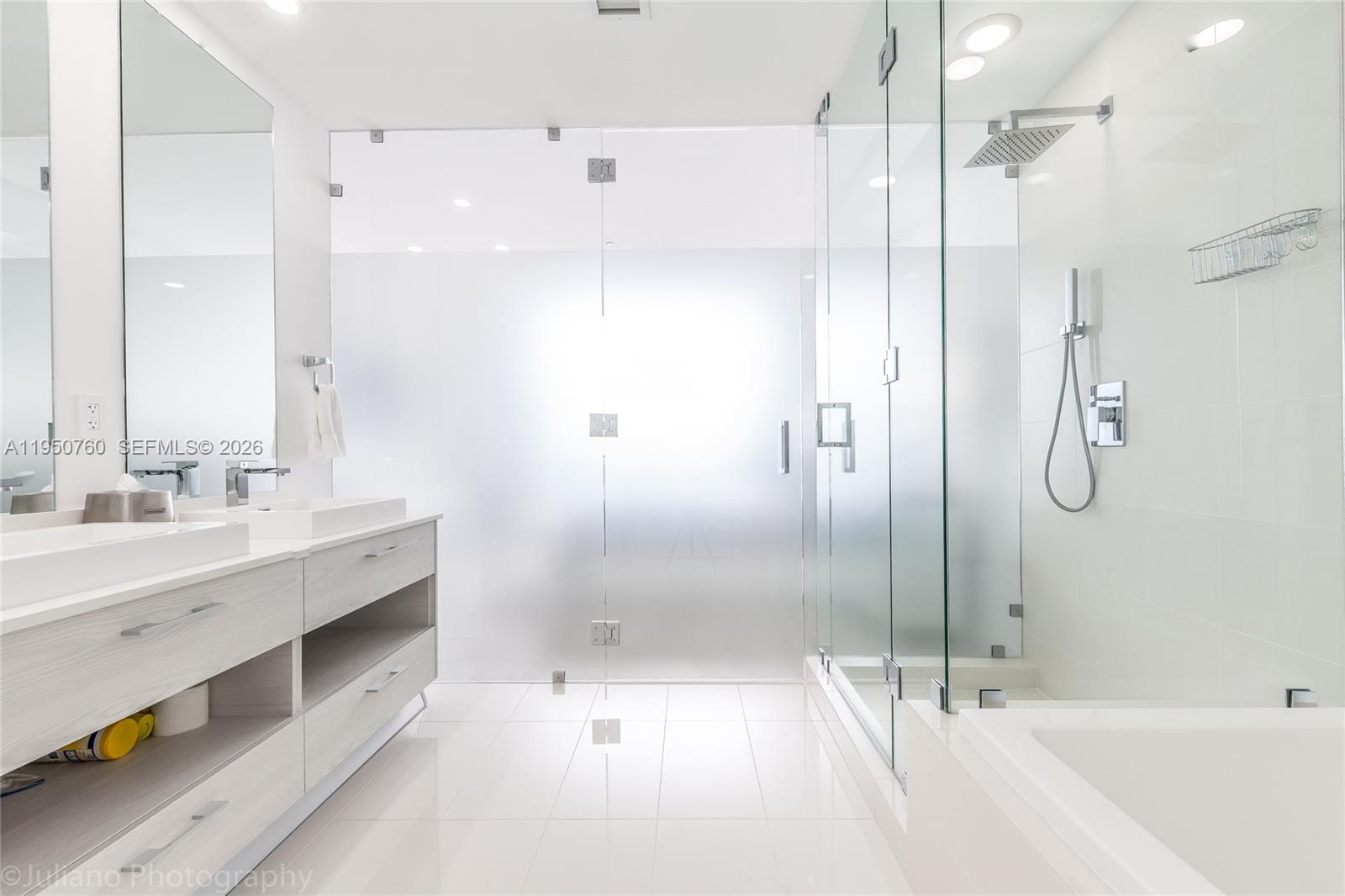 55 Southwest 9th Street, Unit PH4603 Miami, FL 33130 - Photo 25 of 48 a bathroom with a tub sink shower and mirror