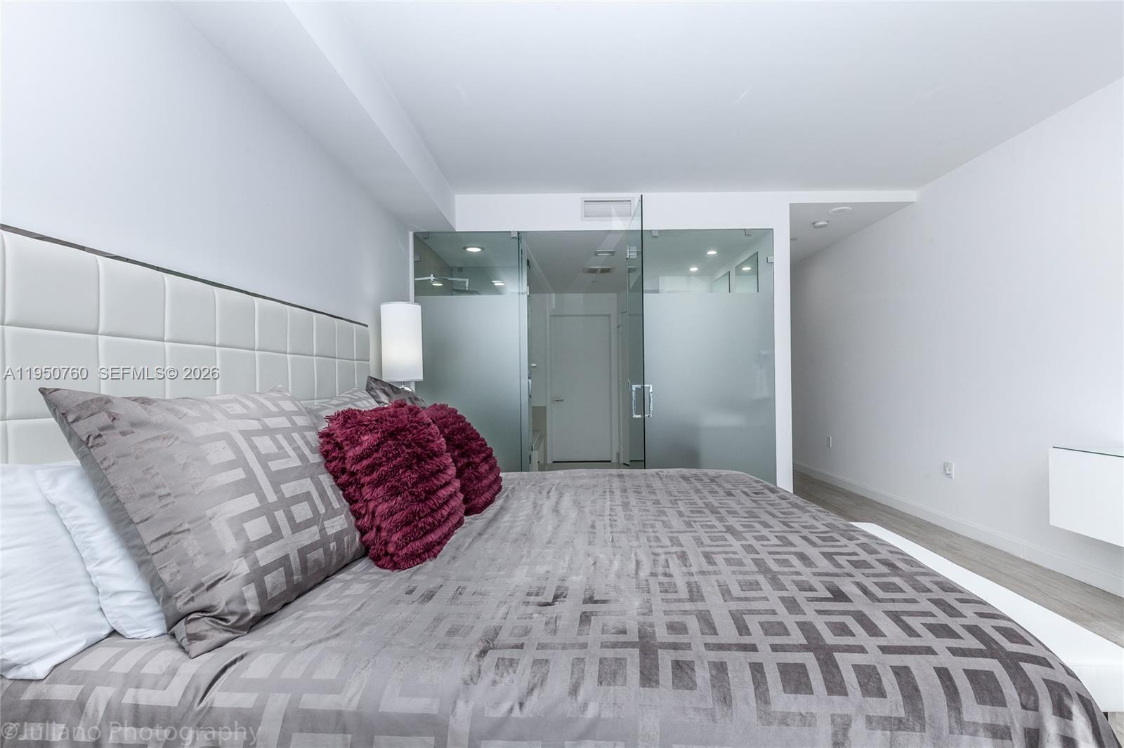 55 Southwest 9th Street, Unit PH4603 Miami, FL 33130 - Photo 28 of 48 a bedroom with a large bed and a chandelier