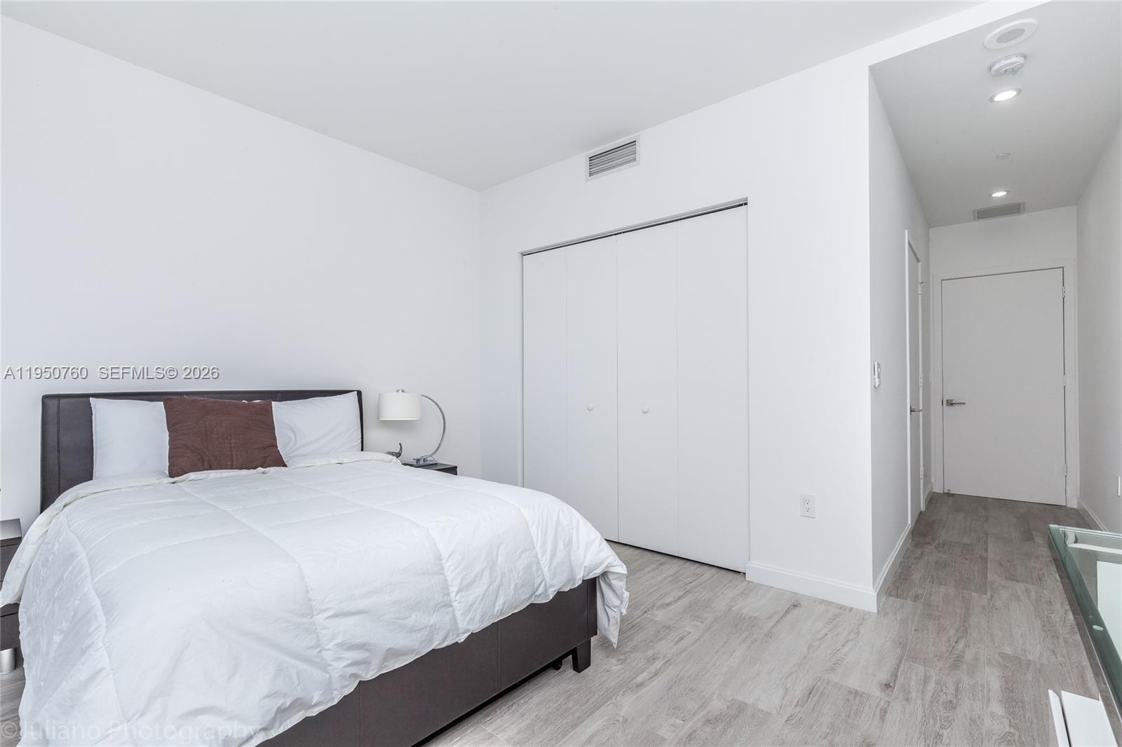 55 Southwest 9th Street, Unit PH4603 Miami, FL 33130 - Photo 33 of 48 a bedroom with a bed and wooden floor