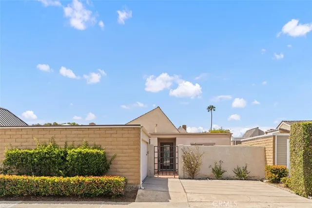 a front view of a house with a yard and potted plants