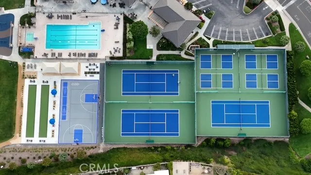 a view of swimming pool with outdoor seating and house in the background