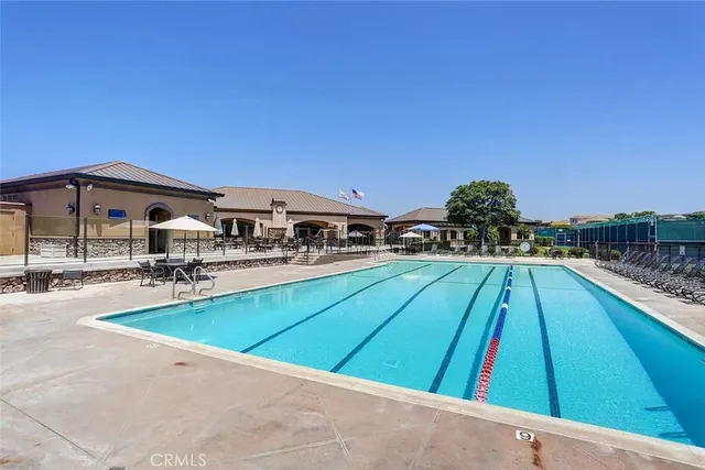 a view of a swimming pool and an outdoor seating
