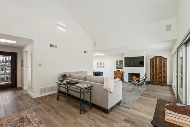 a living room with furniture flat screen tv and a fireplace